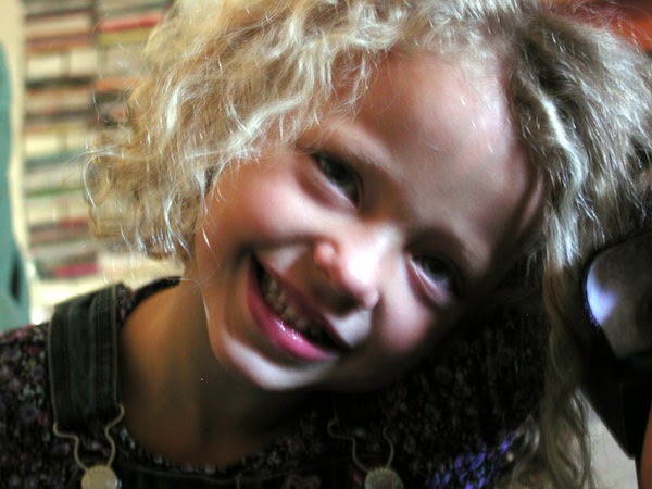 Aja smiling with teeth at age 4